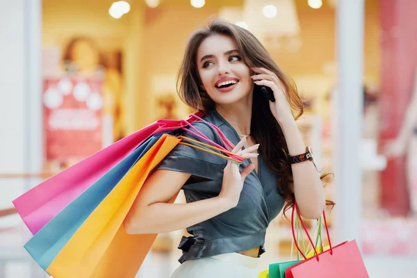 depositphotos_156625116-stock-photo-young-woman-with-shopping-bags